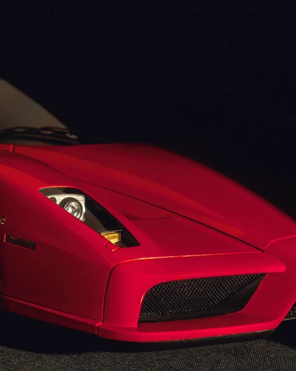 Red Ferrari Enzo photographed in a dark studio