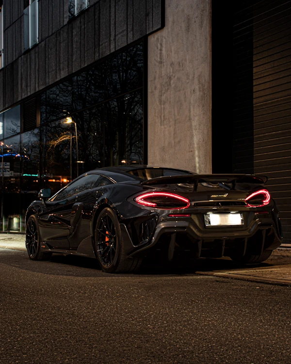 Black McLaren 600LT at night, taillight rings glowing red