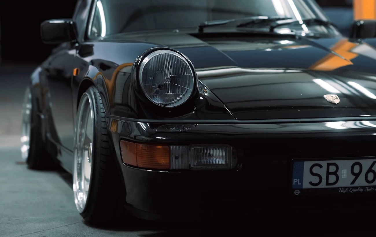Black Porsche in a dark garage