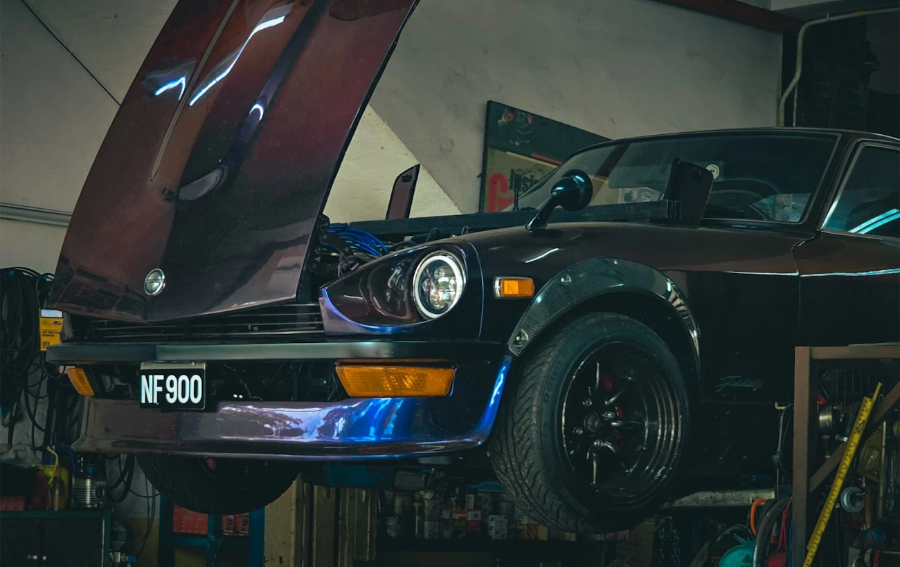 Car in a workshop with its bonnet open